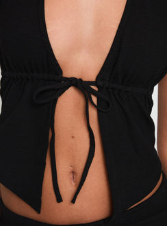 back view of model wearing Princess Polly Obviously Halter Top Black Sleeveless Plunger 