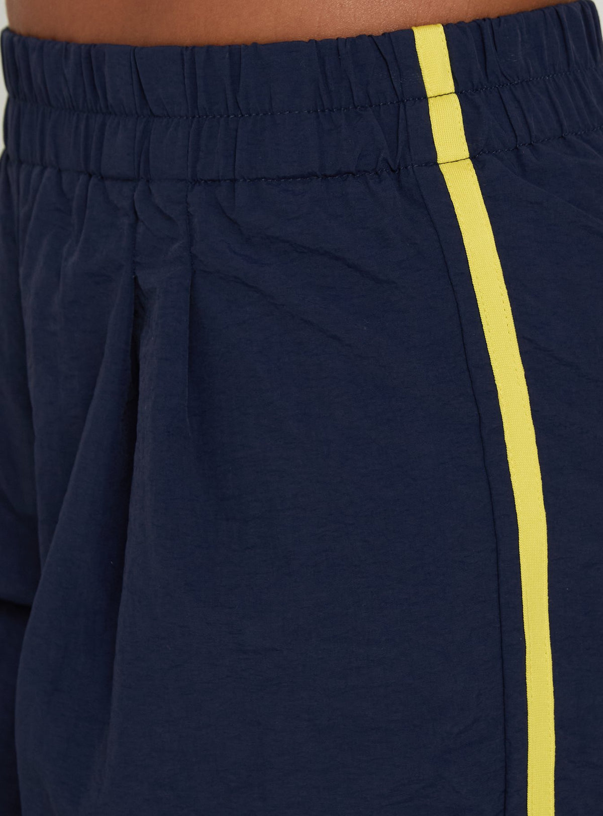 Presenting the Riyah 3/4 Low Rise Nylon Pants Navy in womens-regular-pants styled with yellow striped accent on-body view Princess Polly