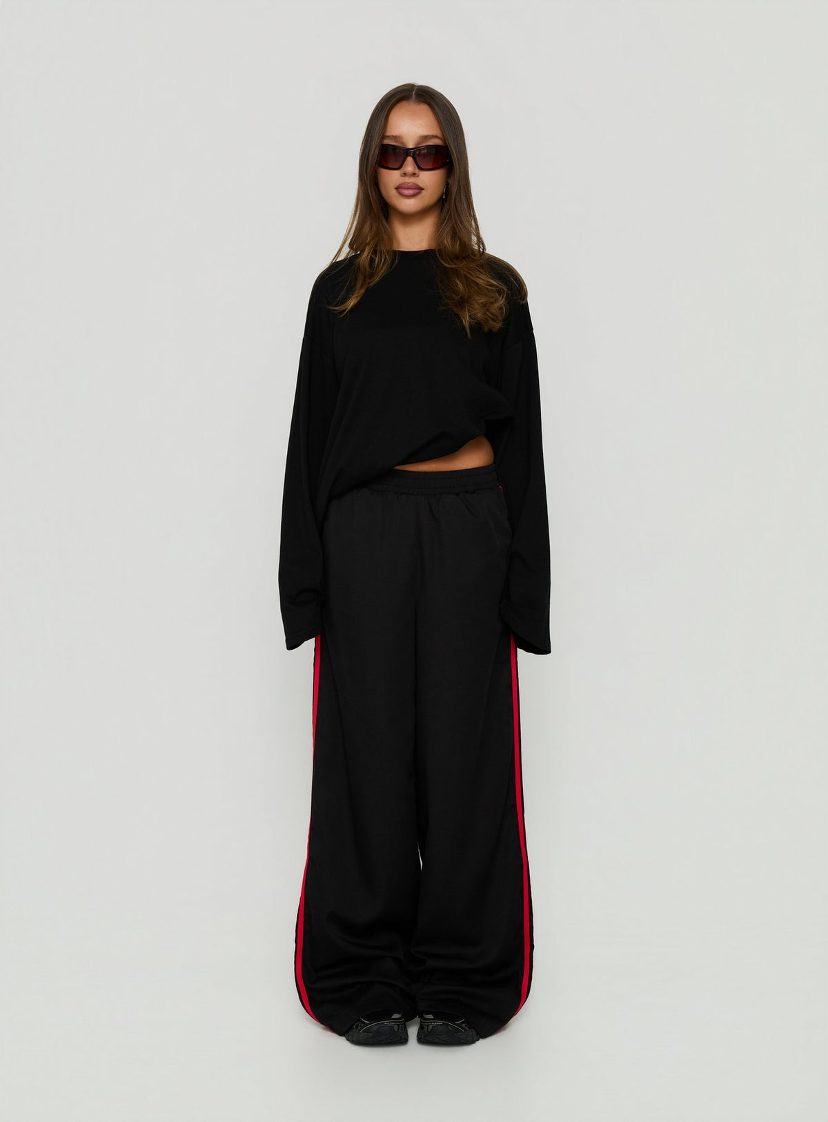Presenting Fielder Track Pants Black / Red in womens-regular-pants with mid-rise on-body view of model wearing