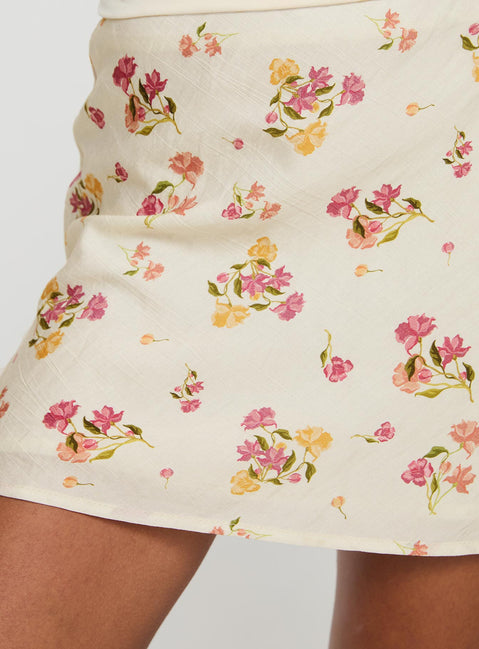   side view of model wearing Princess Polly Sonnet Mini Skirt Cream / Multi Floral Mini Skirts Skirts 
