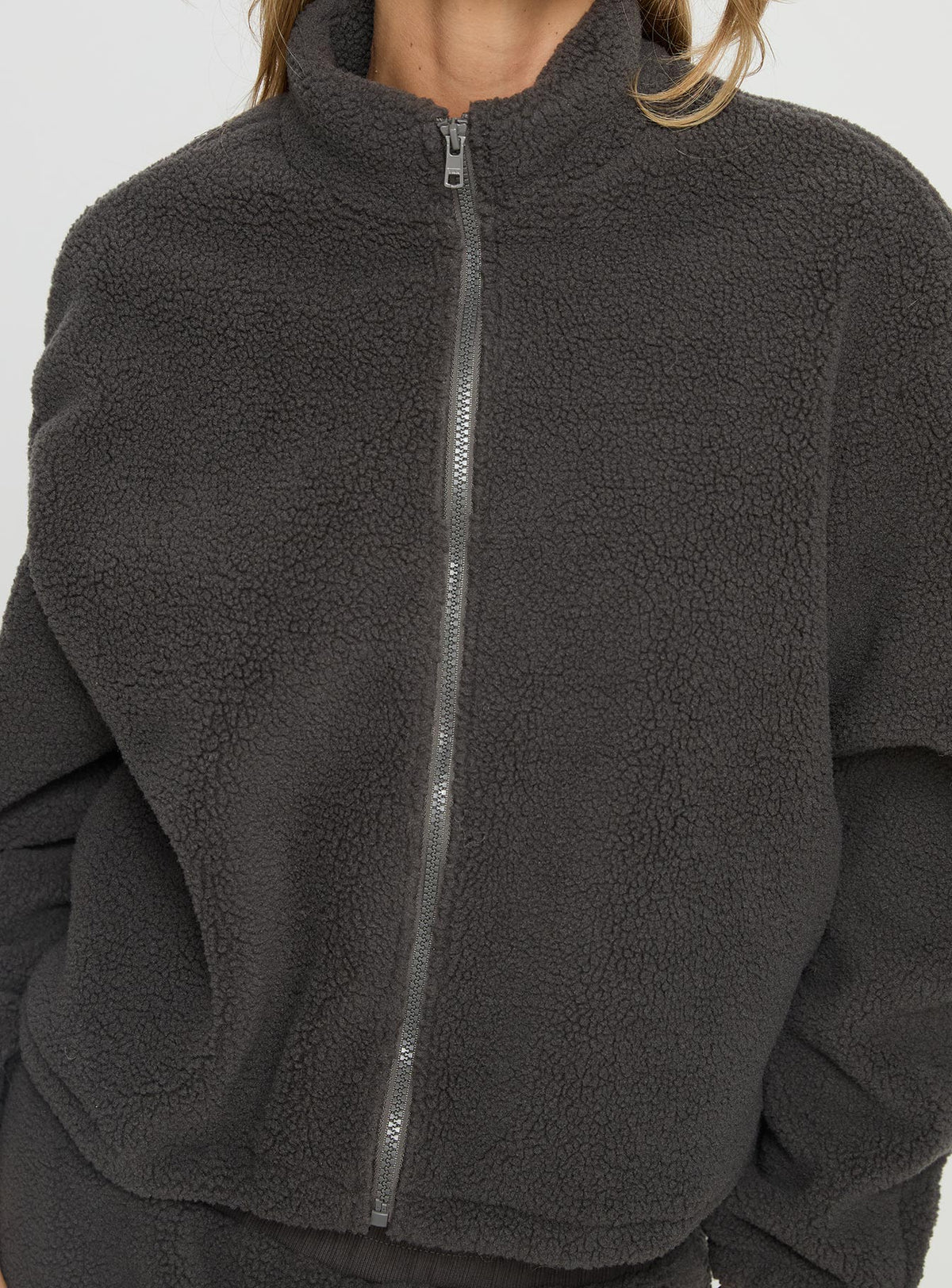 back view of model wearing Princess Polly Siberia Fleece Zip Up Jumper Charcoal regular Jumpers 