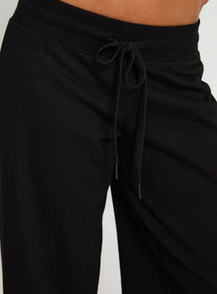 back view of model wearing Princess Polly Mindful Low Rise Pant Black Low Rise Pants Pants 