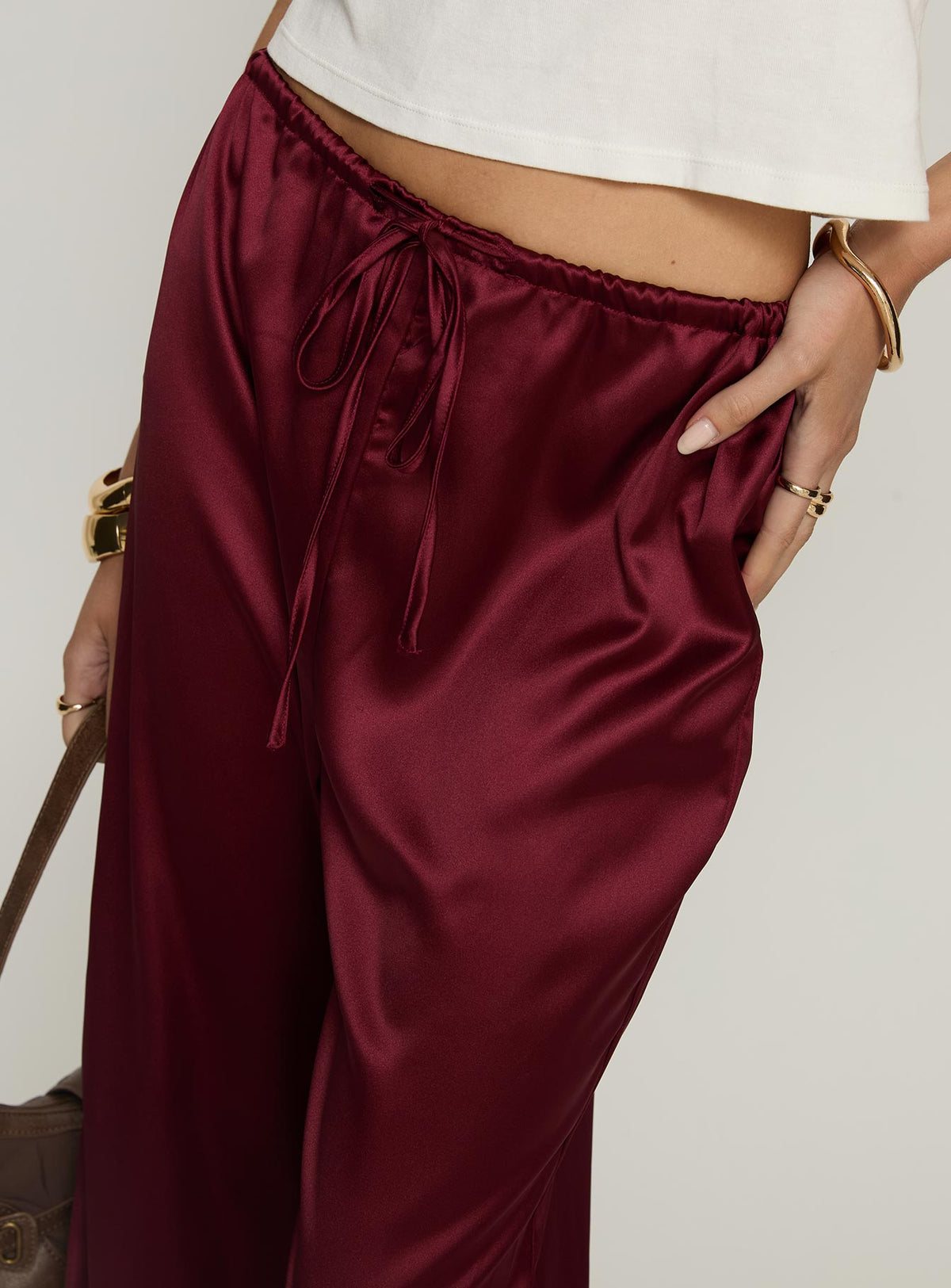 side view of model wearing Princess Polly Soulstar Satin Pants Wine Mid Rise Pants Pants 