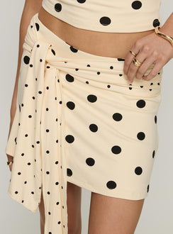 back view of model wearing Princess Polly Porzia Wrap Detail Mini Skirt Cream / Polka Dot Mini Skirts Skirts 