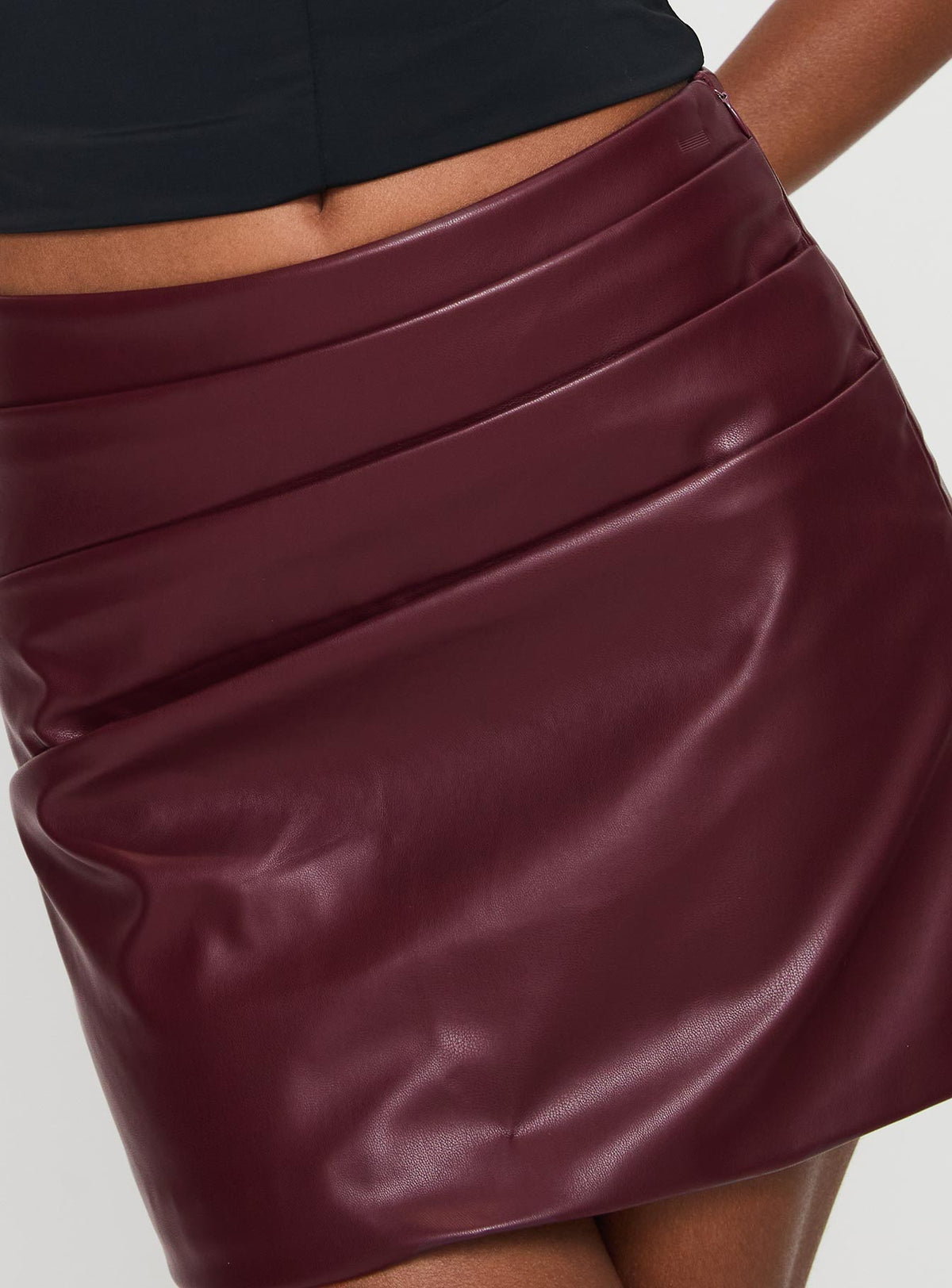 back view of model wearing Princess Polly Kalilah Faux Leather Mini Skirt Red Mini Skirts Skirts 