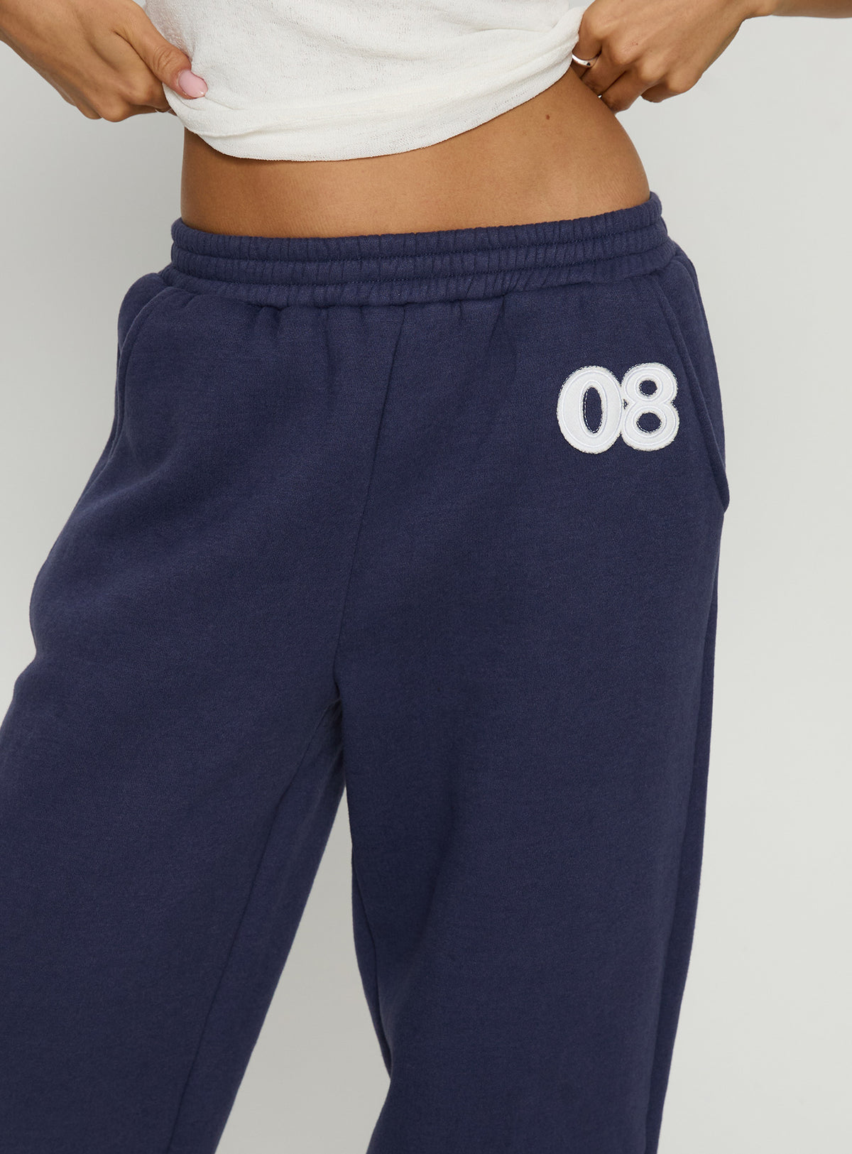 back view of model wearing Princess Polly Route 08 Barrel Track Pant Navy Mid Rise Pants Pants 