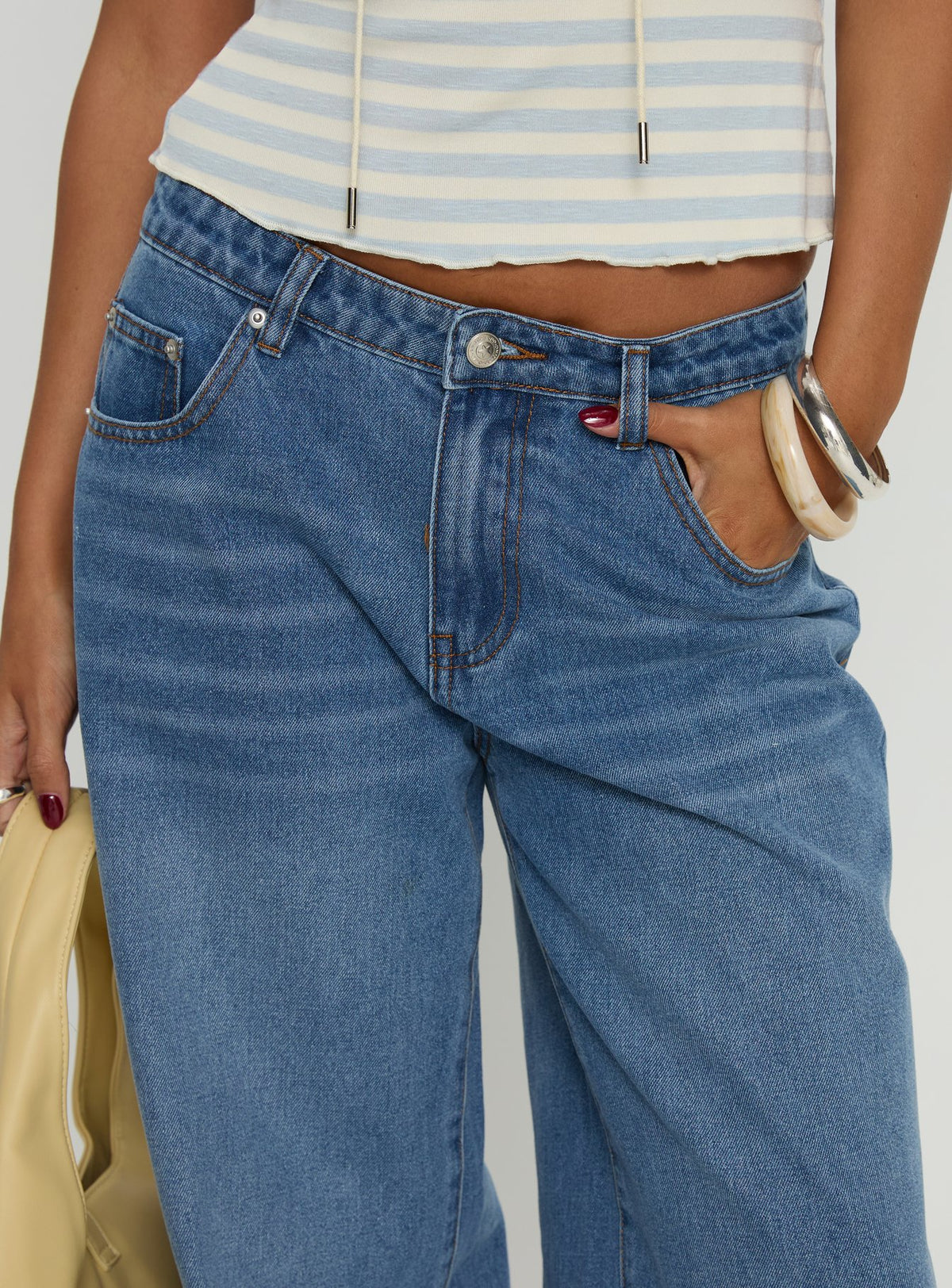 back view of model wearing Princess Polly Jacobie Mid Rise Wide Leg Jeans Mid Blue Wash Mid Rise Jeans Jeans 