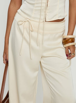back view of model wearing Princess Polly Aubrette Satin Tie Pants Cream High Rise Pants 