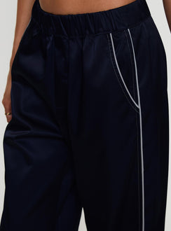 back view of model wearing Princess Polly Travalta Satin Track Pant Navy Low Rise Pants Pants 