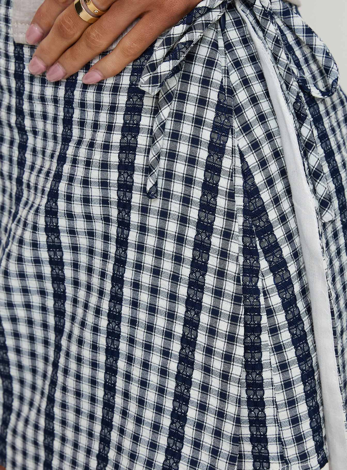 back view of model wearing Princess Polly Gulliver Tie Side Mini Skort Navy Gingham 