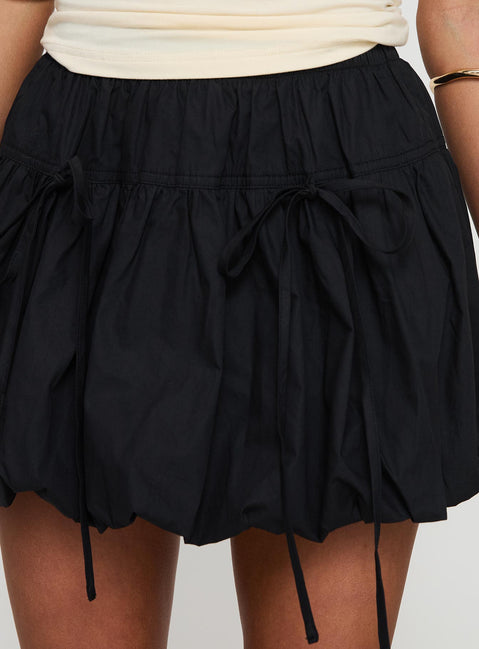 back view of model wearing Princess Polly Vannes Bubble Hem Mini Skirt Black Mini Skirts Skirts 