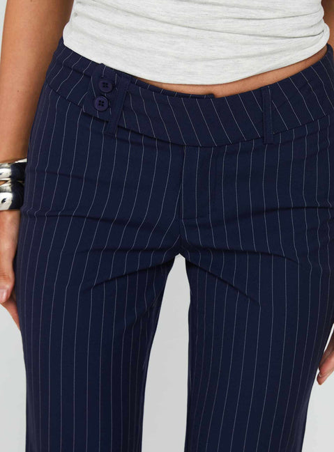 side view of model wearing Princess Polly Kinkirk Flared Pants Navy Pinstripe Low Rise Pants Pants 