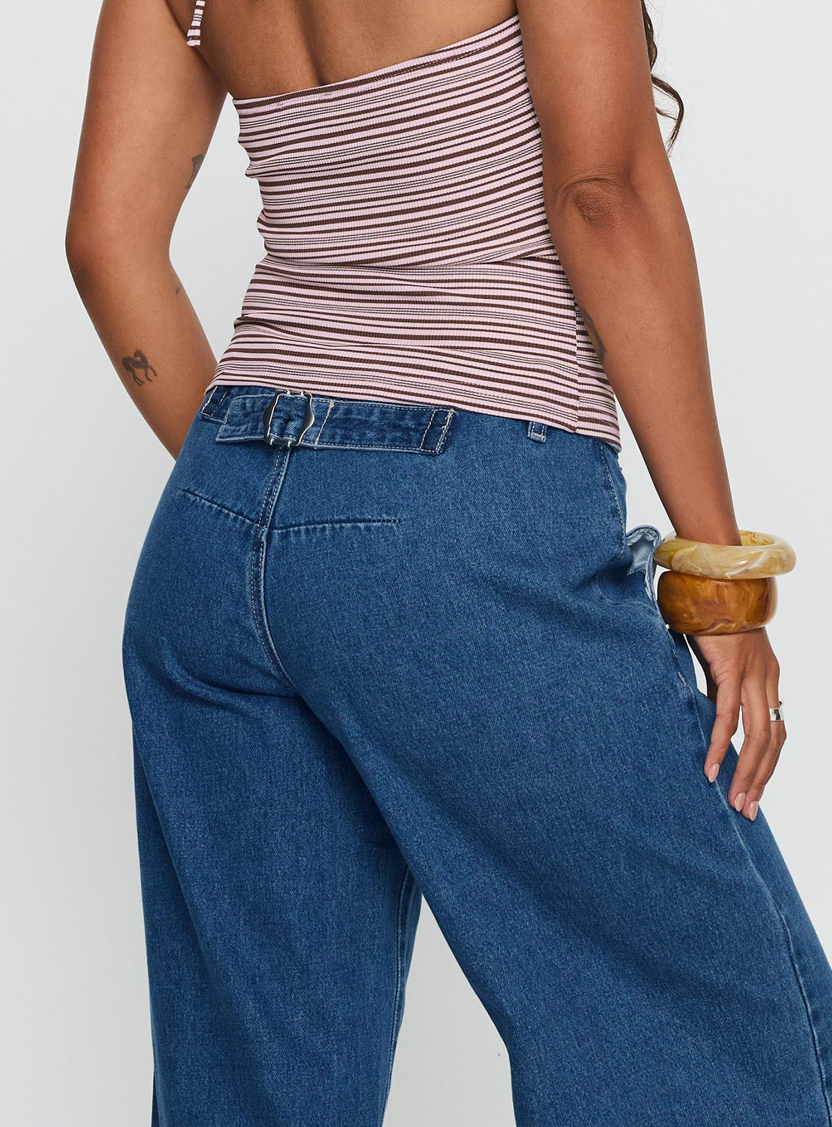 back view of model wearing Princess Polly Polaris Mid Rise Straight Leg Jeans Mid Blue Mid Rise Jeans Jeans 