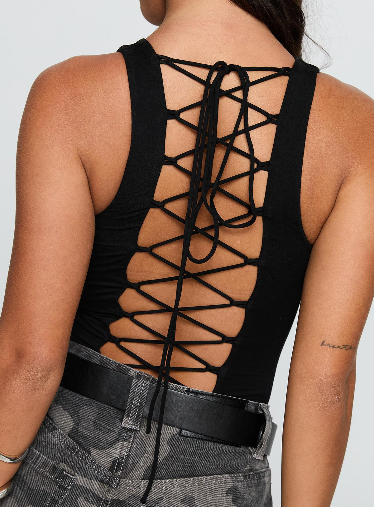 side view of model wearing Princess Polly Majesty Tie Back Bodysuit Black Sleeveless Bodysuit 