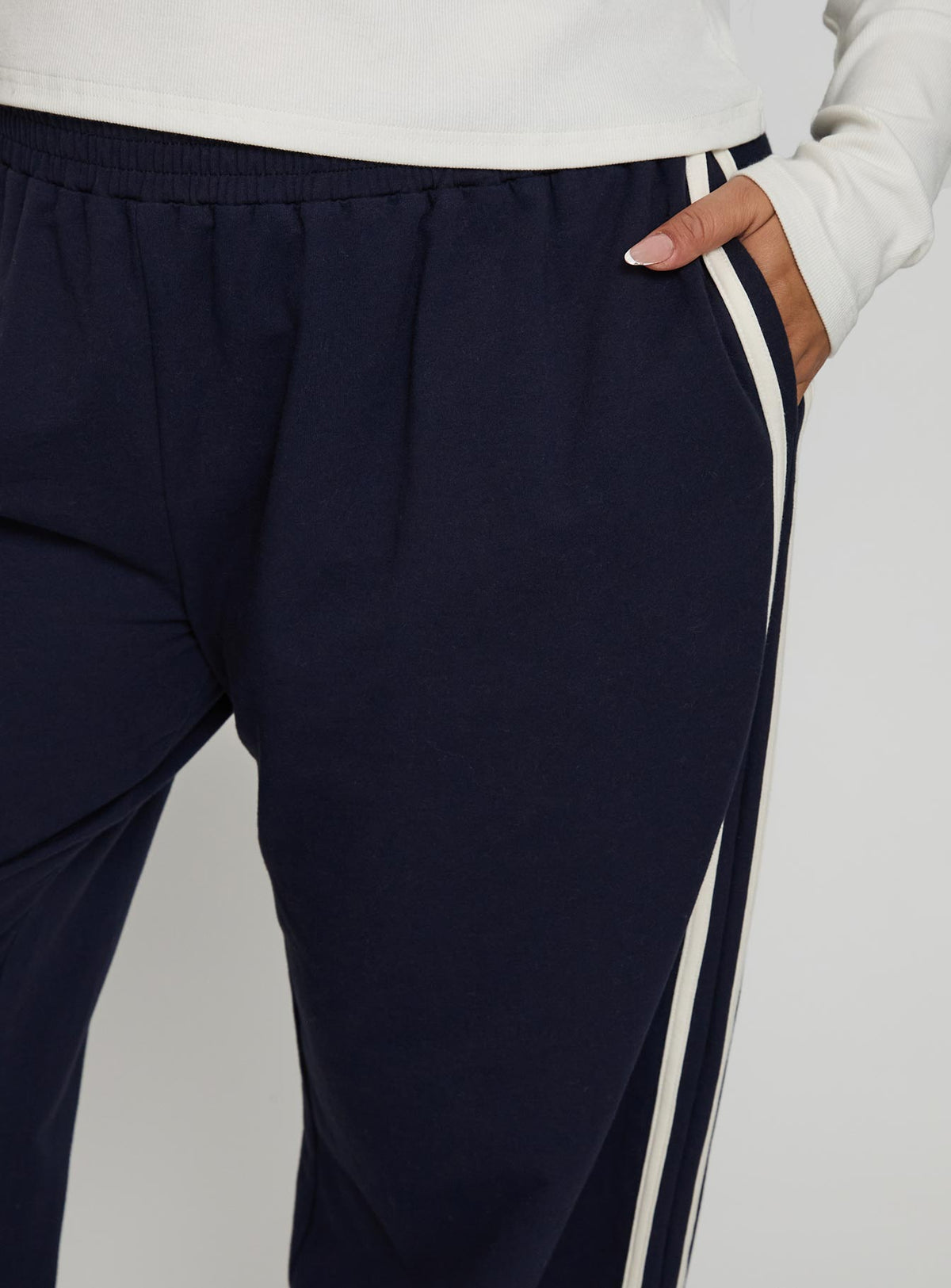 back view of model wearing Princess Polly Circuit Track Pants Navy Curve Pants 