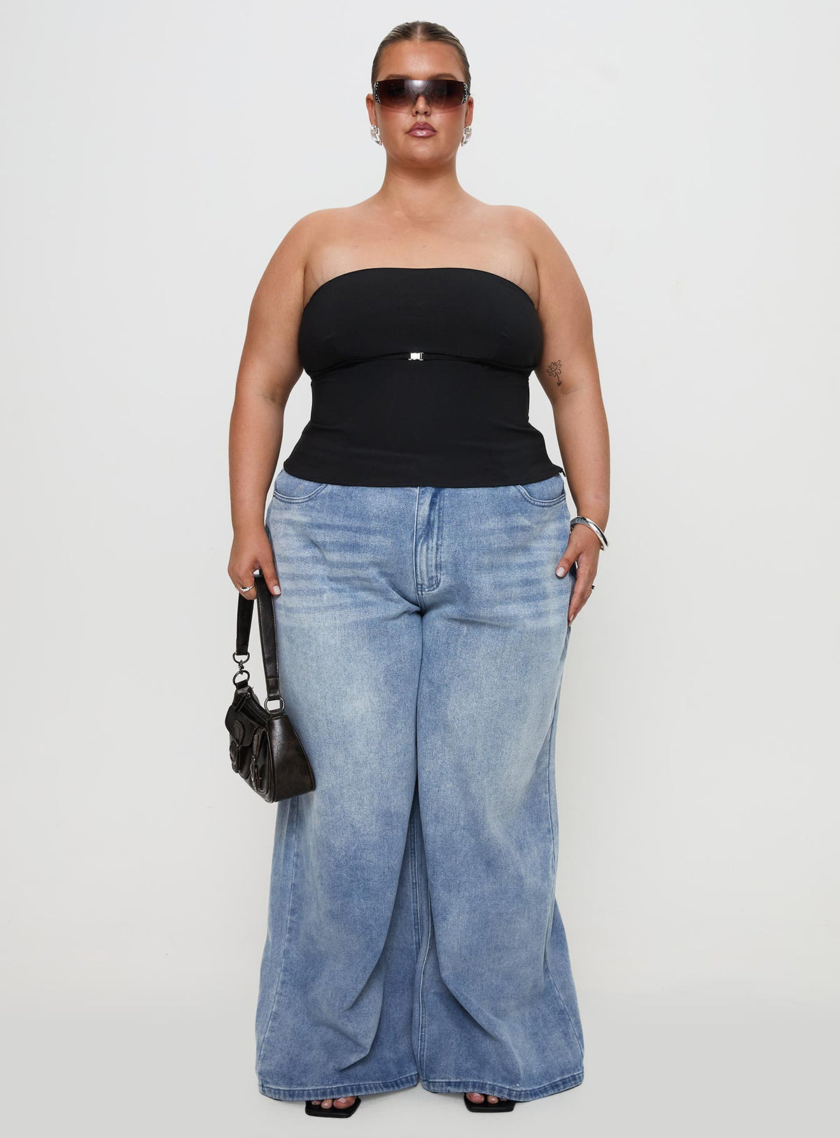 side view of model wearing Princess Polly Flounce Strapless Top Black Curve Sleeveless straight 