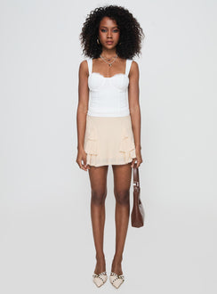 back view of model wearing Princess Polly Foalie Ruffle Mini Skirt Beige Mini Skirts Skirts 