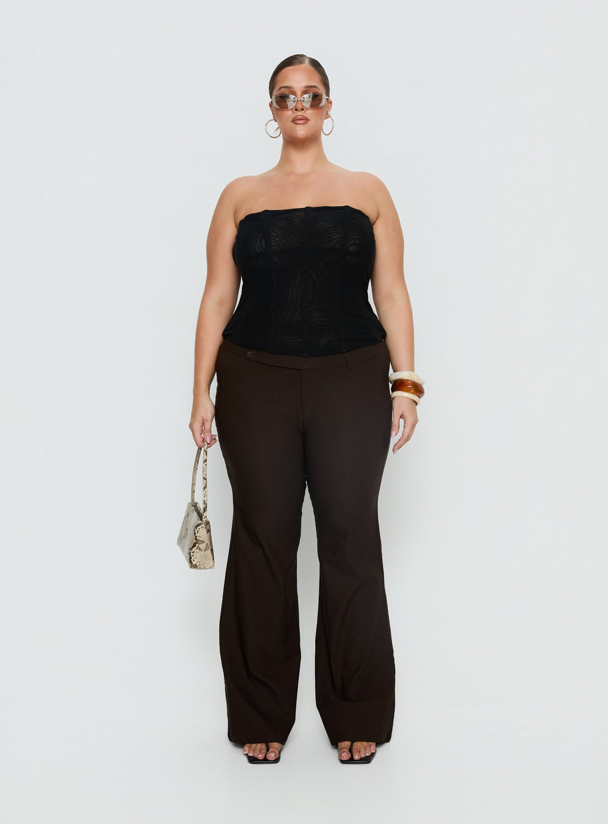 back view of model wearing Princess Polly Kinkirk Flared Pants Chocolate Curve Mid Rise Pants Pants 