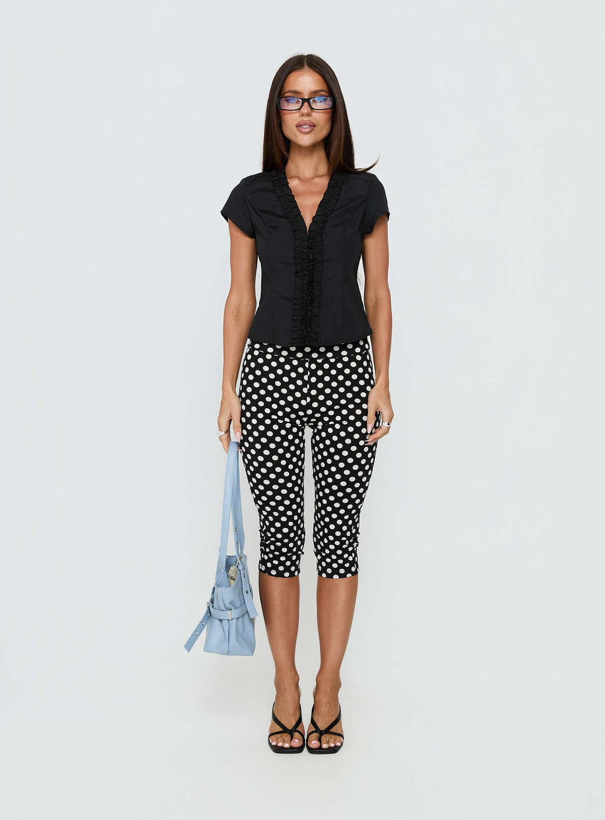 side view of model wearing Princess Polly Isadonna Capri Pants Black Polka Dot Mid Rise Pants Pants 