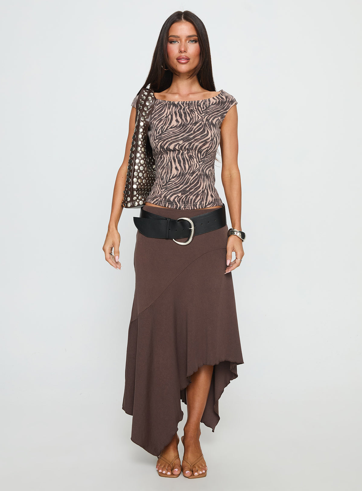   side view of model wearing Princess Polly Futura Asymmetrical Midi Skirt Chocolate Midi Skirts Skirts 