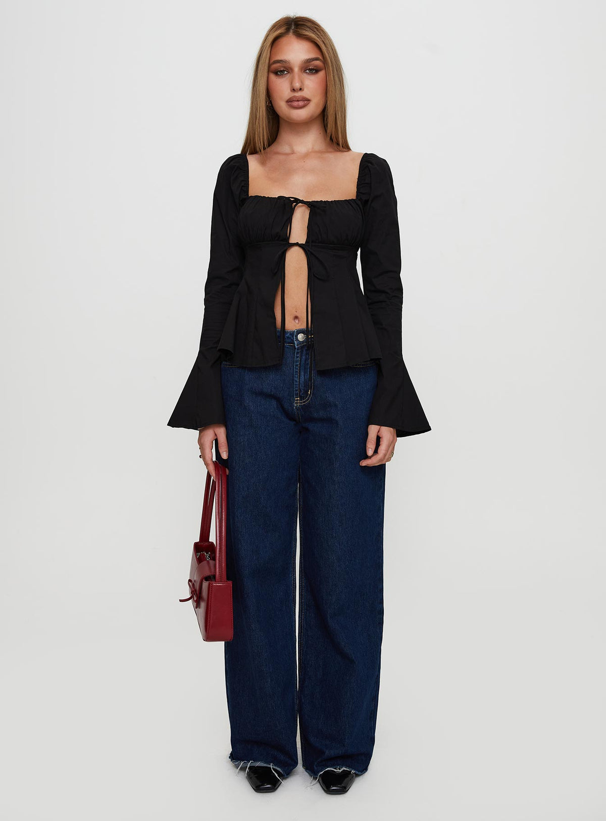 side view of model wearing Princess Polly Lilibette Tie Up Long Sleeve Top Black Full Sleeves Square Neck 