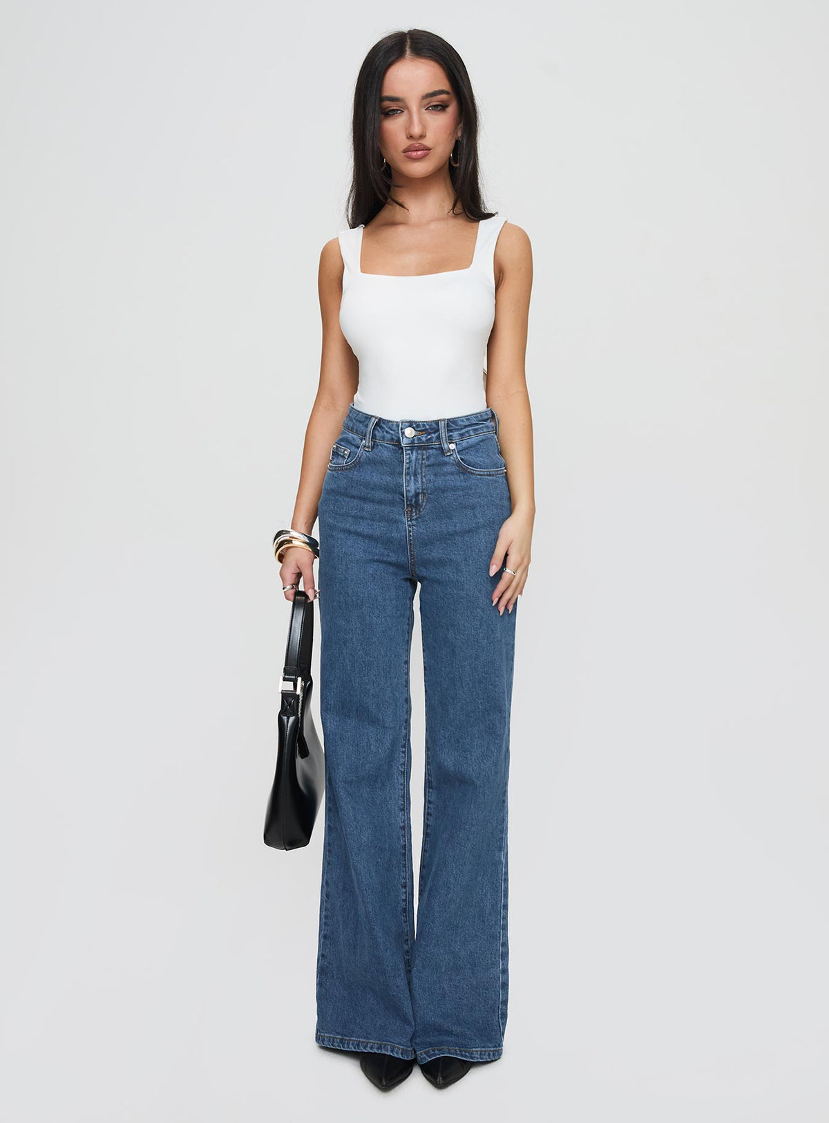 side view of model wearing Princess Polly Lucille High Rise Flared Jeans Mid Wash High Rise Jeans Jeans 
