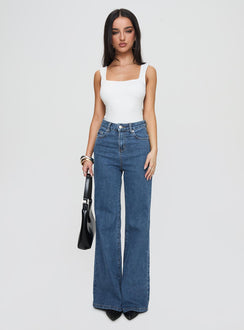 side view of model wearing Princess Polly Lucille High Rise Flared Jeans Mid Wash High Rise Jeans Jeans 