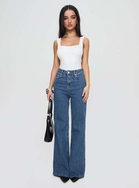 side view of model wearing Princess Polly Lucille High Rise Flared Jeans Mid Wash High Rise Jeans Jeans 