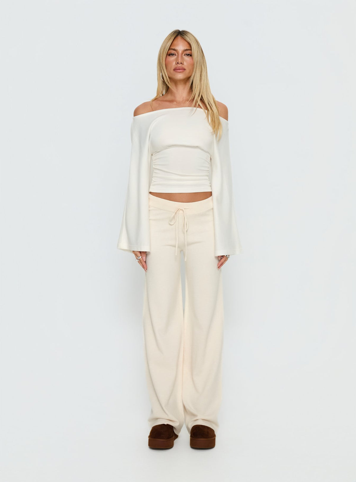 side view of model wearing Princess Polly Felisha Low Waist Knit Pants White Mid Rise Pants Pants 