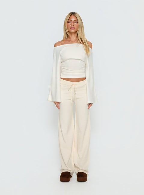 side view of model wearing Princess Polly Felisha Low Waist Knit Pants White Mid Rise Pants Pants 