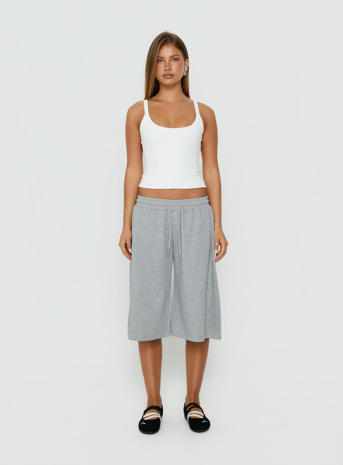 Showcasing the Nikko Longline Fleece Shorts Grey Marle in womens regular pants with mid-rise front view of model wearing Princess Polly