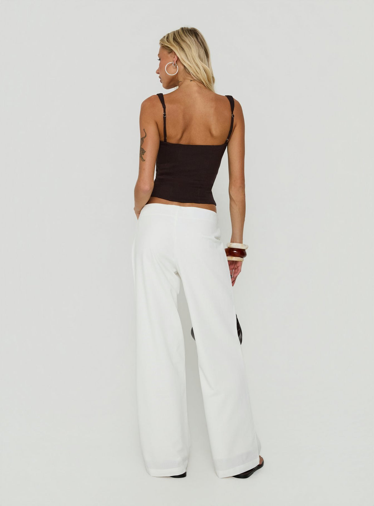 Explore the Agazia No Waist Low Rise Straight Pants White in womens regular pants with low-rise back view of model wearing