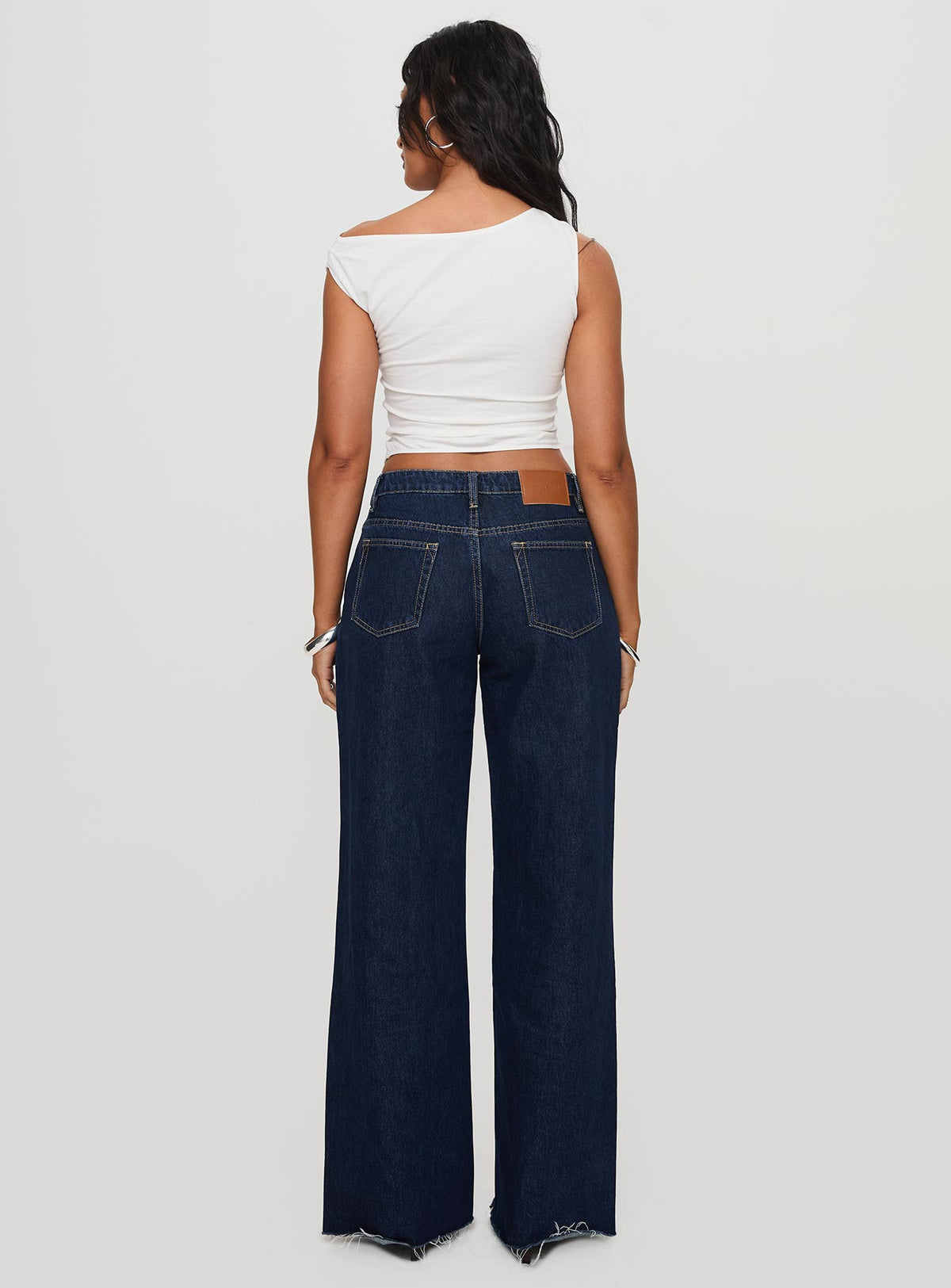 back view of model wearing Princess Polly Darla Low Rise Straight Jean Dark Wash Petite Low Rise Jeans 