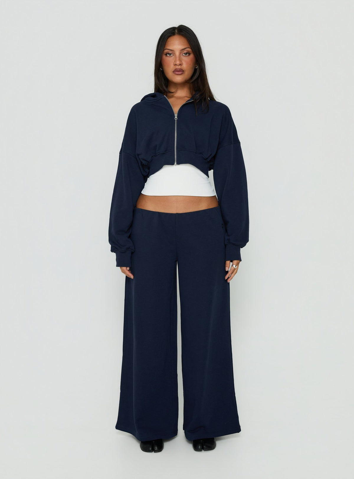 Showcasing the Lanna Fleece Zip Through Cropped Hoodie Navy womens-jumpers with short length front view of model wearing Princess Polly