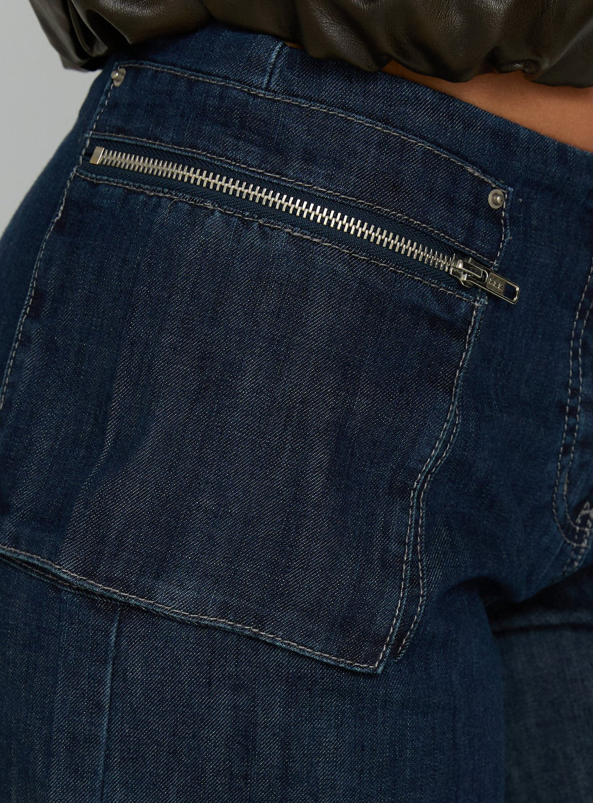 back view of model wearing Princess Polly Paltrow Mid Rise Wide Leg Cargo Jeans Dark Blue Wash Mid Rise Jeans Jeans 
