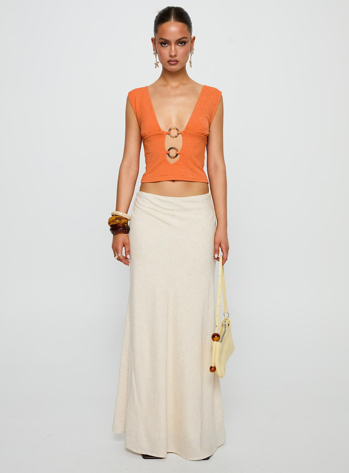 side view of model wearing Princess Polly Steward Top Orange Sleeveless Plunger 