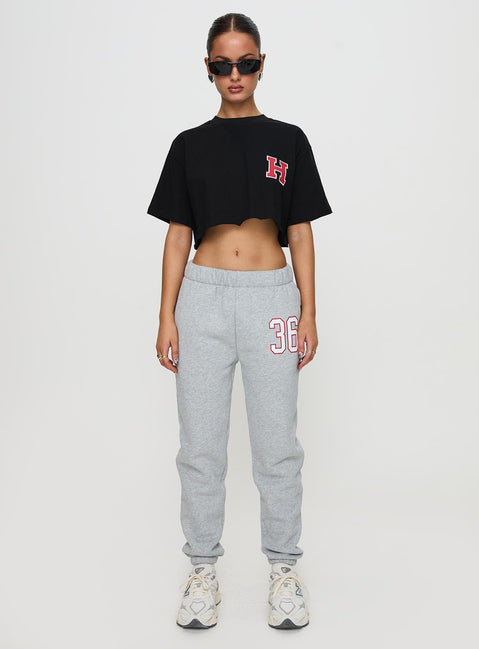 side view of model wearing Princess Polly Harvard Graphic Track Top Black Short Sleeves Crew Neck 