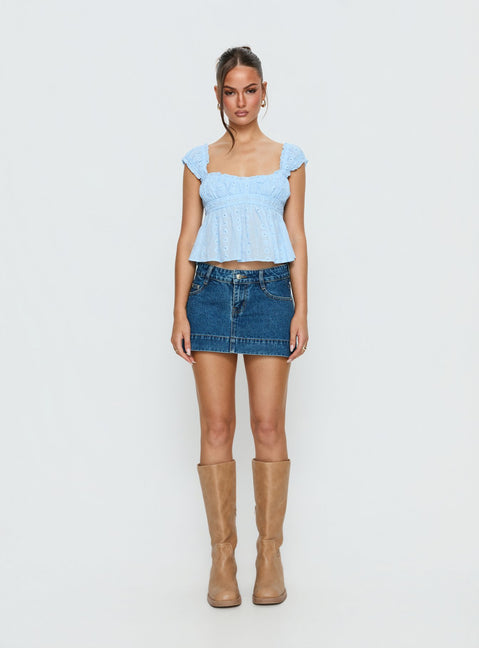   front view of model wearing Princess Polly Warna Low Rise Denim Mini Skirt Mid Blue Wash Mini Skirts Skirts 