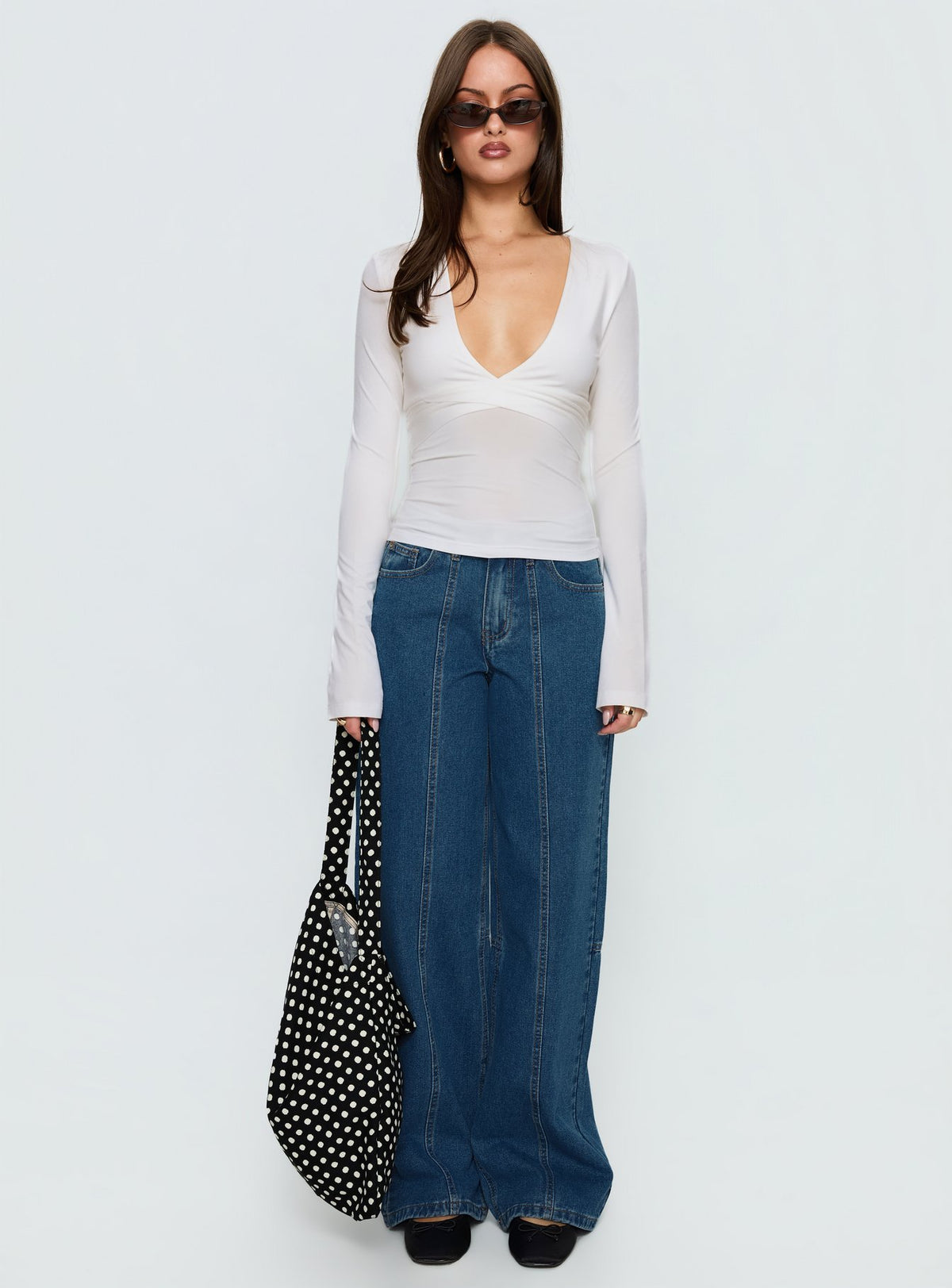 side view of model wearing Princess Polly Lando Low Rise Straight Leg Jeans Mid Blue Wash Mid Rise Jeans Jeans 