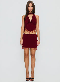   side view of model wearing Princess Polly Ginah Bead Tassel Mini Skirt Red Mini Skirts Skirts 