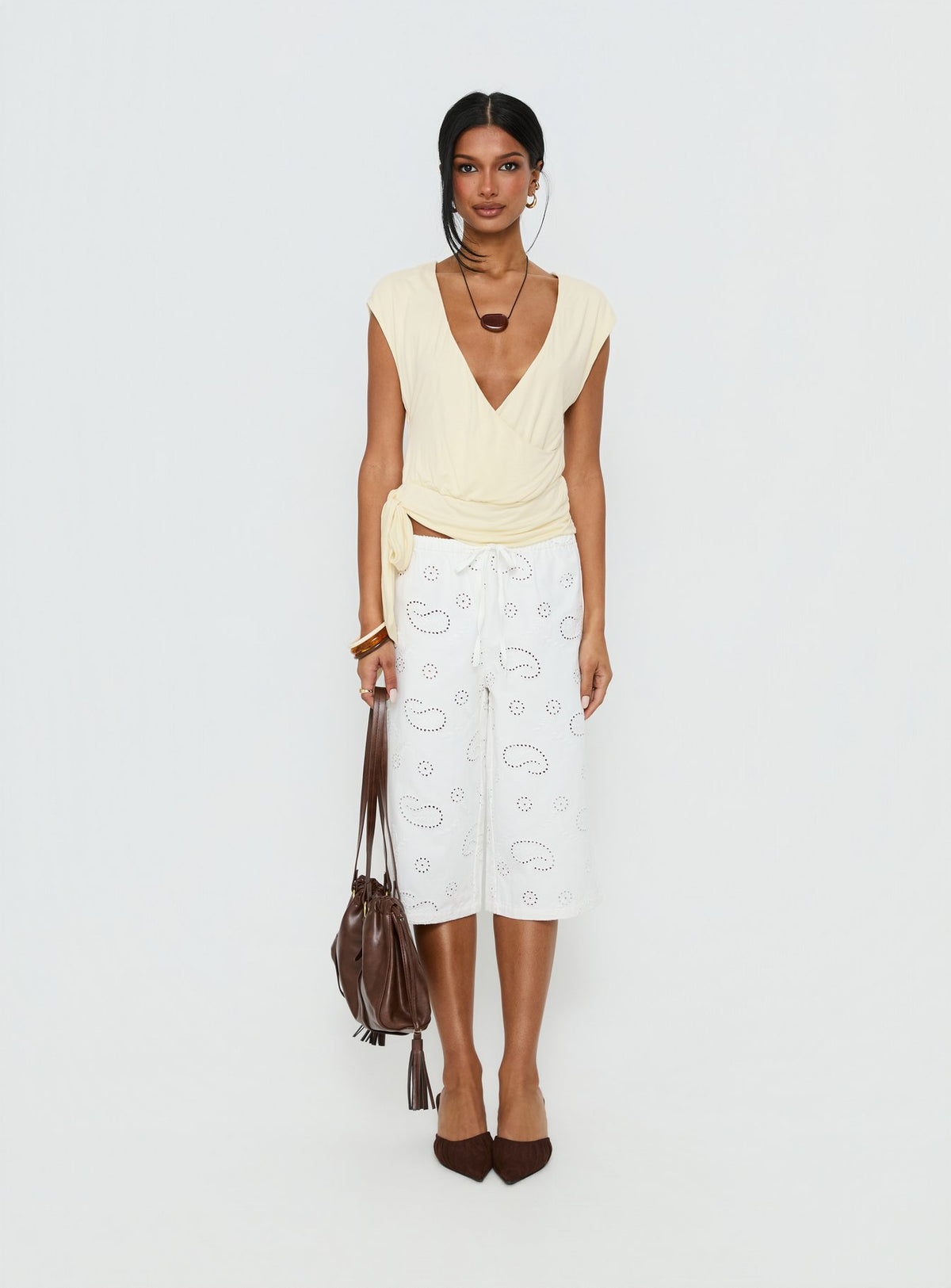 side view of model wearing Princess Polly Roda Anglaise Longline Shorts White Mid Rise Pants Pants 