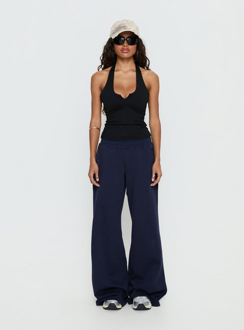 back view of model wearing Princess Polly Summits Flared Track Pants Navy Mid Rise Pants Pants 