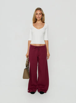 Crafted from cherry fabric, the Kennah Wide Leg Sweat Pants in womens-regular-pants with mid-rise waist front view of model wearing Princess Polly