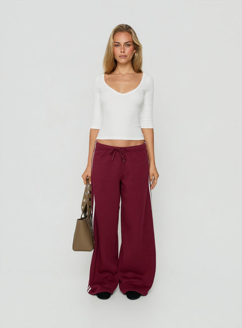 Crafted from cherry fabric, the Kennah Wide Leg Sweat Pants in womens-regular-pants with mid-rise waist front view of model wearing Princess Polly