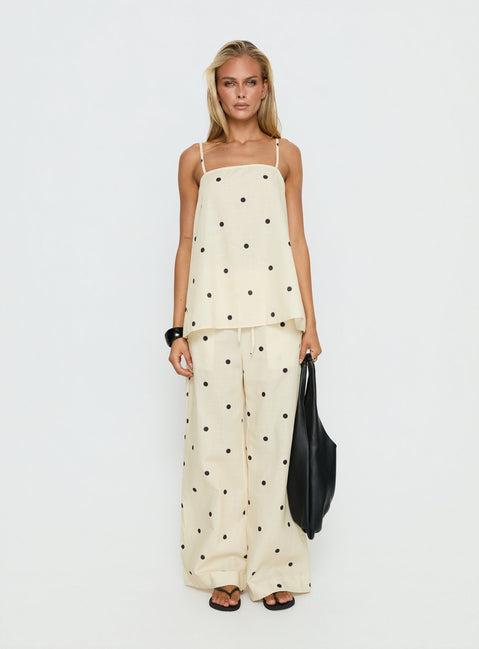 Showcasing Bellara Tie Waist Pants Yellow Polka in womens regular pants with mid-rise and wide-leg styling front view of model wearing Princess Polly