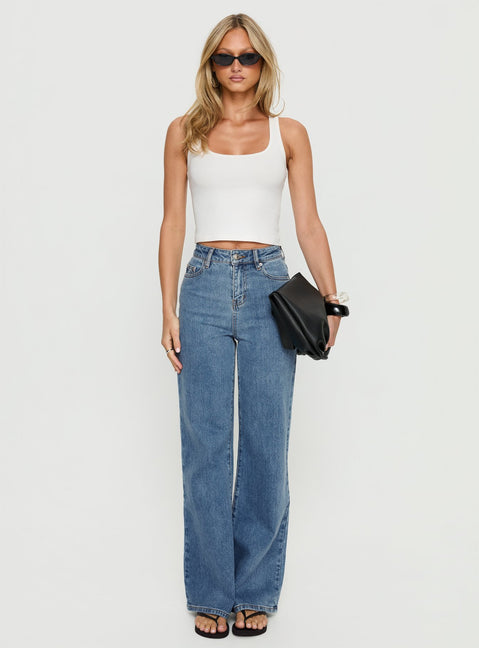 front view of model wearing Princess Polly Thearlie High Rise Flared Jeans Mid Blue Wash High Rise Jeans Jeans 