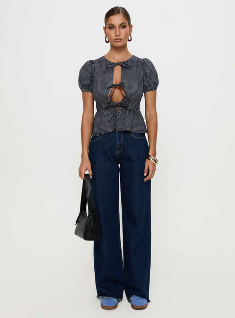 side view of model wearing Princess Polly Verah Tie Up Puff Sleeve Top Navy Check Short Sleeves Scoop Neck 