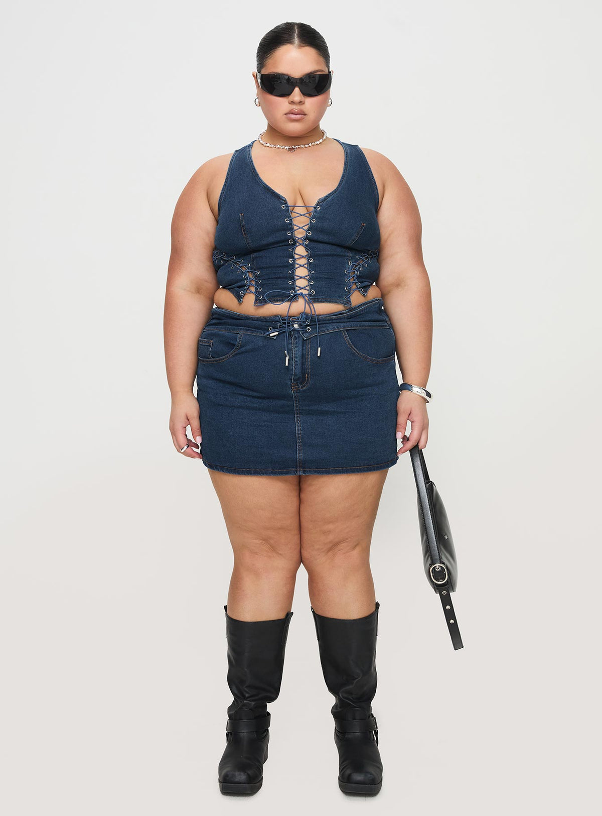   front view of model wearing Princess Polly Popular Low Rise Mini Skirt Mid Blue Wash Curve Mini Skirts Skirts 