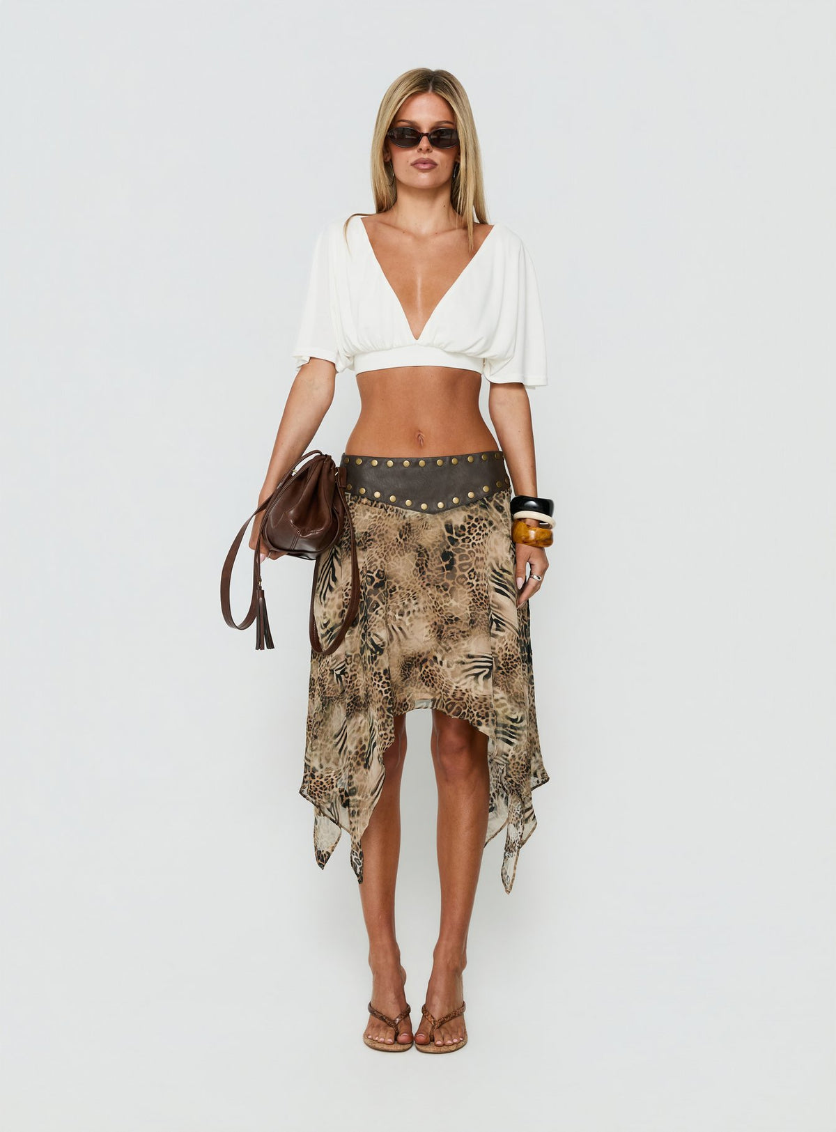 Shop the Dark Mirage Asymmetrical Midi Skirt in Leopard print with relaxed fit and belt detail front view of model wearing Princess Polly
