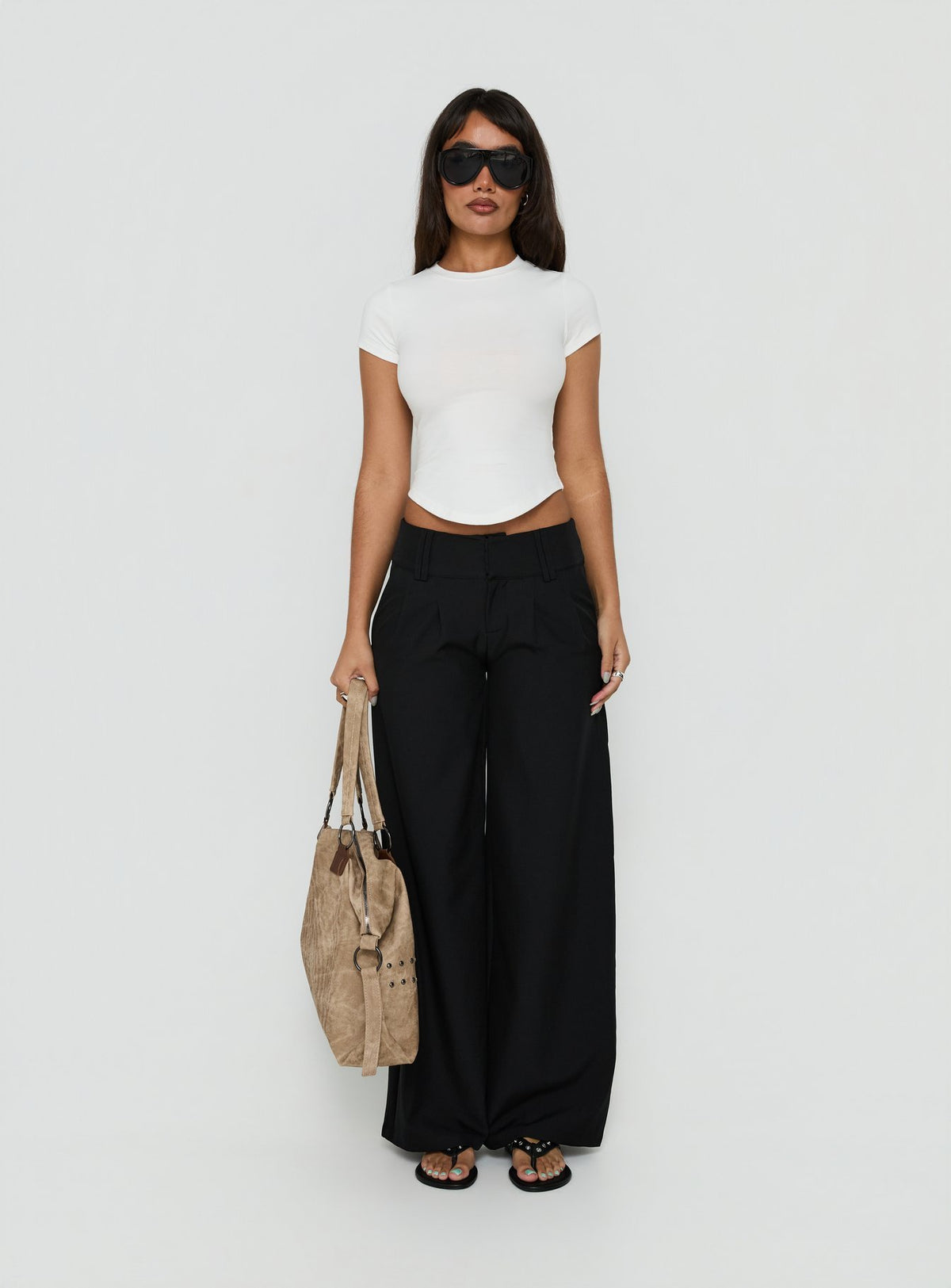 Featuring the Loved Up Low Rise Baggy Pants Black Tall in womens-regular-pants with low-rise waist front view of model wearing Princess Polly